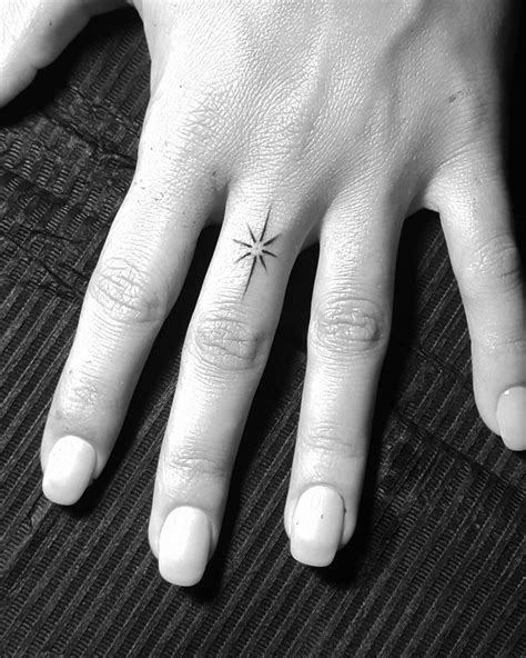 star tattoo on finger